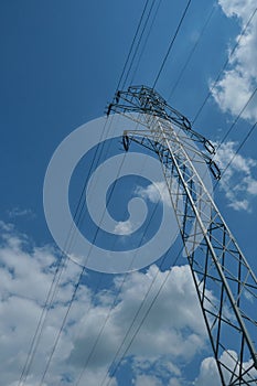 High voltage electricity transmission pylon blue sky noon hours