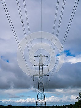 A high voltage electricity transmission pylon and overhead power lines - part of the national grid for the distribution of power