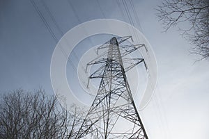 A high voltage electricity transmission pylon in winter in the UK