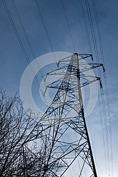 A high voltage electricity transmission pylon in winter in the UK