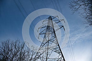 A high voltage electricity transmission pylon in winter in the UK