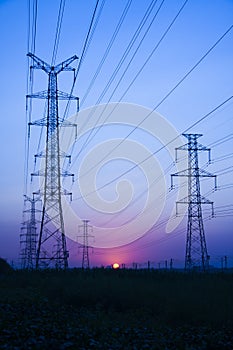 High voltage electricity transmission tower at sunset