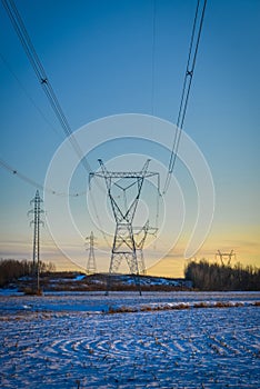 High voltage electricity transmission towers by aerial cables in winter