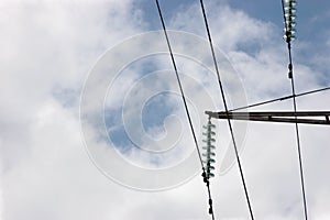 High voltage grid electric power line electricity pilon traverse glass insulators and transmission wires, large detailed sky photo