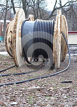 High voltage, high tension underground power cable for electricity and telecommunication wires is unwound near the place of