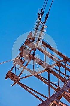 High voltage insulators in row on power tower