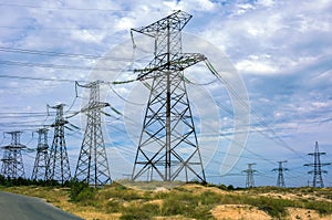 High-voltage line with electric pylons on the background of clou