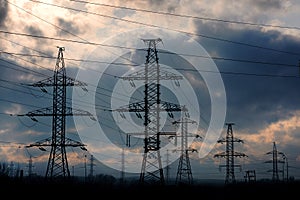 High-voltage line and a pole against the background of an overcast sky and the upcoming storm and weather.