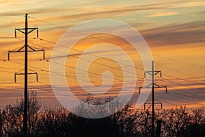 High-voltage overhead power line with wires and transmission tower (electricity pylon) poles