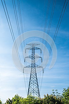 High voltage pole with blue sky background, Electric transmission line system for large industrial plants.