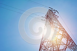 High voltage pole on blue sky background. High voltage tower