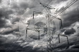 High voltage pole and dark clouds on sky