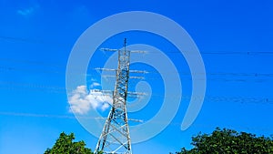 High voltage pole on sky background