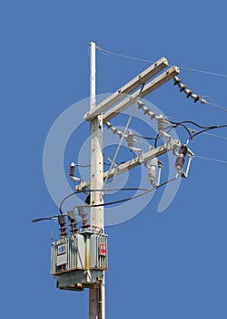 High Voltage Pole with Transformer isolated on Blue Background