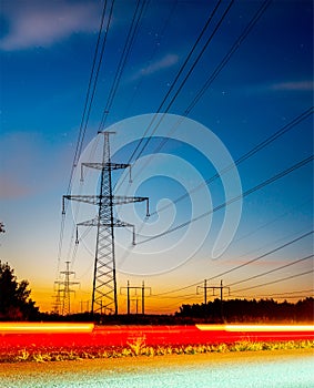 High voltage post. High-voltage tower sky background, besides the highw