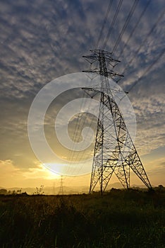 high voltage post.High-voltage tower sky background in countryside at sunset. The sun rise