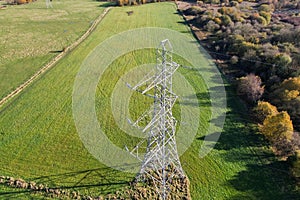 High voltage post,High voltage tower sky field grass housing esate aerial drone view