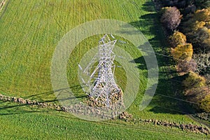 High voltage post,High voltage tower sky field grass housing esate aerial drone view