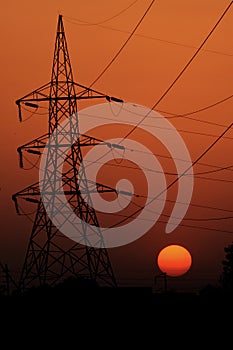 high voltage post.High-voltage tower with sunrise