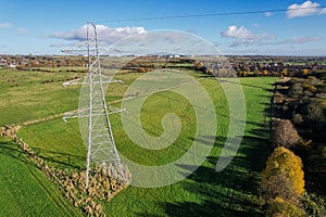 High voltage post,High voltage tower sky field grass housing esate aerial drone view