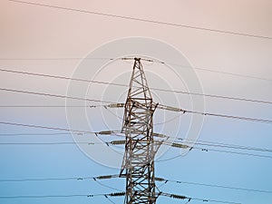 High voltage post or transmission tower and clear sunset sky as background