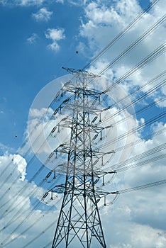 High voltage power electric pole wire blue cloudy sky