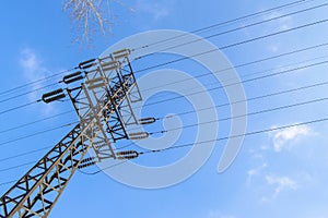 High-voltage power line 110 kV, metal support, wires, insulators, against the blue sky