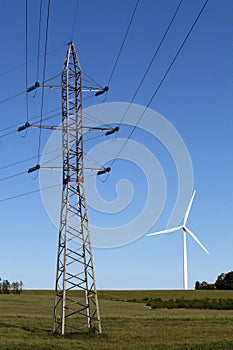 High voltage power line against the background of a wind turbine