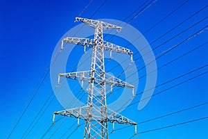 High-voltage power line and blue color metal prop with many electrical wires vertical