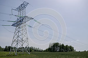 High-voltage power line in forest-steppe landscape. Transmission tower with two-level structure with insulators and wires.
