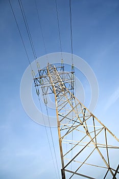 High-voltage power line metal prop over blue sky