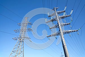 High-voltage power line metal prop over clear cloudless blue sky