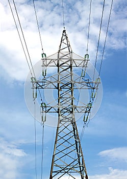 High-voltage power line metal prop over cloudy blue sky