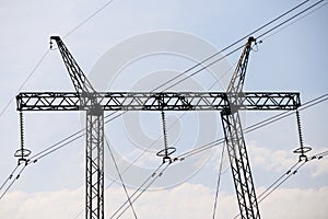 High voltage power line pole close-up. Electric powerline on metal pole, steel tower. Electrification, energy concept