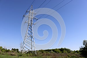 High voltage power line support against blue sky background. Electrical industry