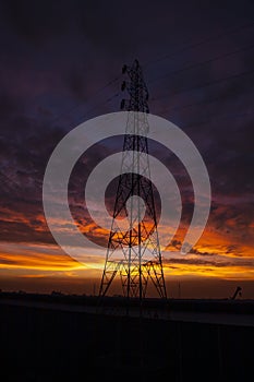 High voltage power line tower with beautiful sky at sunset, stock photo