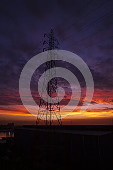 High voltage power line tower with beautiful sky at sunset, stock photo
