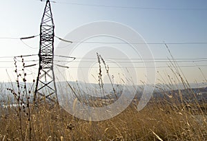 High voltage power line tower in the mountain