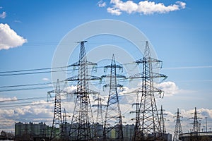 High-voltage power lines in the background of the city. Electric distribution station.