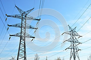 High voltage power lines on blue sky background. Electric transmission pylon tower. Wire electrical energy. Electricity concept