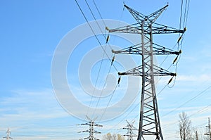 High voltage power lines on blue sky background. Electric transmission pylon tower. Wire electrical energy. Electricity concept