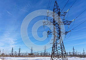 High voltage power lines at blue sky. electricity distribution station.