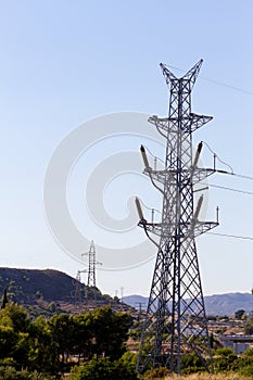 High voltage power lines and electric transmission pylon outdoor landscape