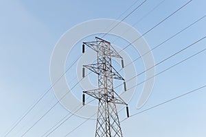 High-voltage power lines electricity transmission pylon on blue sky background