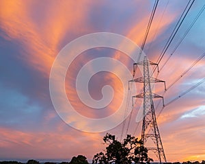 High-voltage power lines passing through a green field.