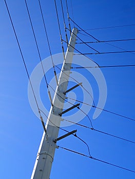 High Voltage Power Lines run through a large metal Utility pole