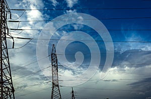 High-voltage power lines at storm clouds.