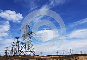 High-voltage  power lines at storm clouds.