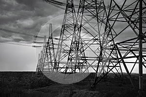 High-voltage power lines at storm clouds.