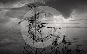 High-voltage power lines at storm clouds